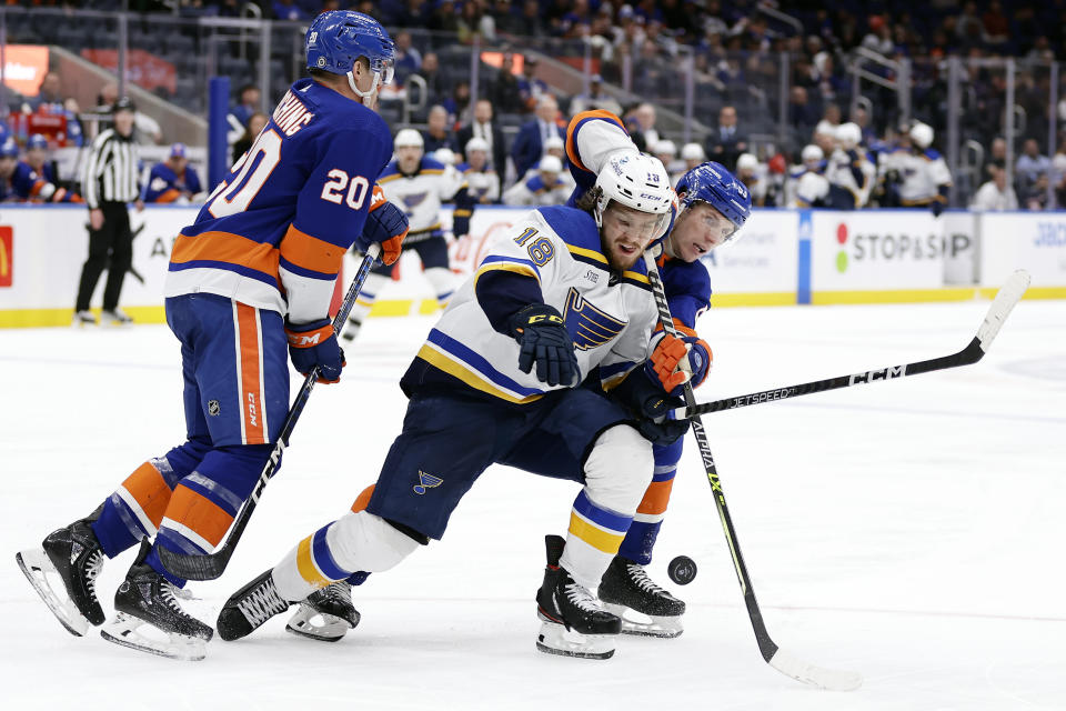 St. Louis Blues center Robert Thomas (18) competes for the puck and New York Islanders center Casey Cizikas, right, during the third period of an NHL hockey game Tuesday, Dec. 6, 2022, in Elmont, N.Y. The Blues won 7-4. (AP Photo/Adam Hunger)