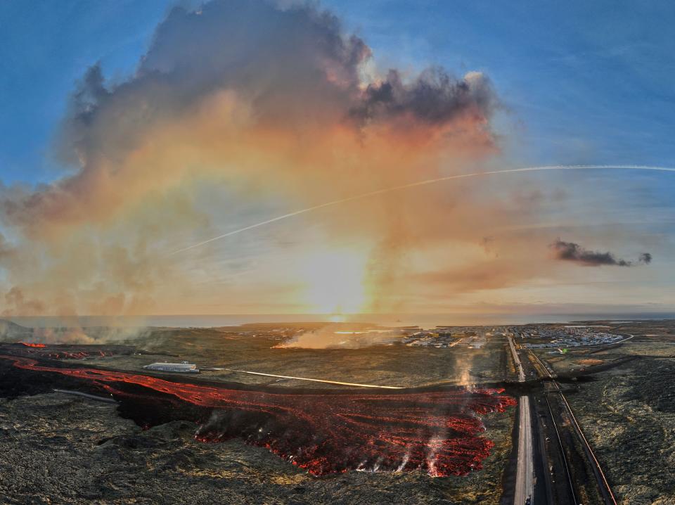 Aerial view taken on January 14, 2024 shows flowing lava close to a road leading to the southwestern Icelandic town of Grindavik (AFP via Getty Images)