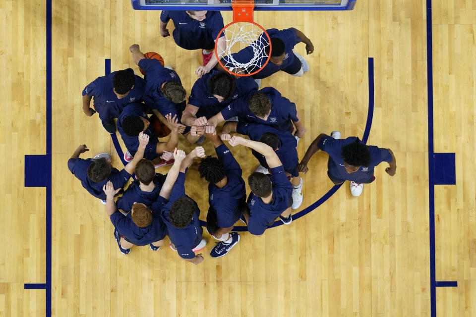 Pennsylvania players huddle before an NCAA college basketball game against Kentucky, Saturday, Dec. 9, 2023, in Philadelphia. (AP Photo/Matt Slocum)