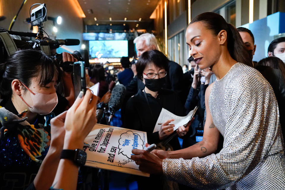 TOKYO, JAPAN – DECEMBER 10: Zoe Saldana greets fans during the “Avatar: The Way of Water” Japan Premiere at TOHO Cinemas Hibiya on December 10, 2022 in Tokyo, Japan. (Photo by Christopher Jue/Getty Images for Disney)