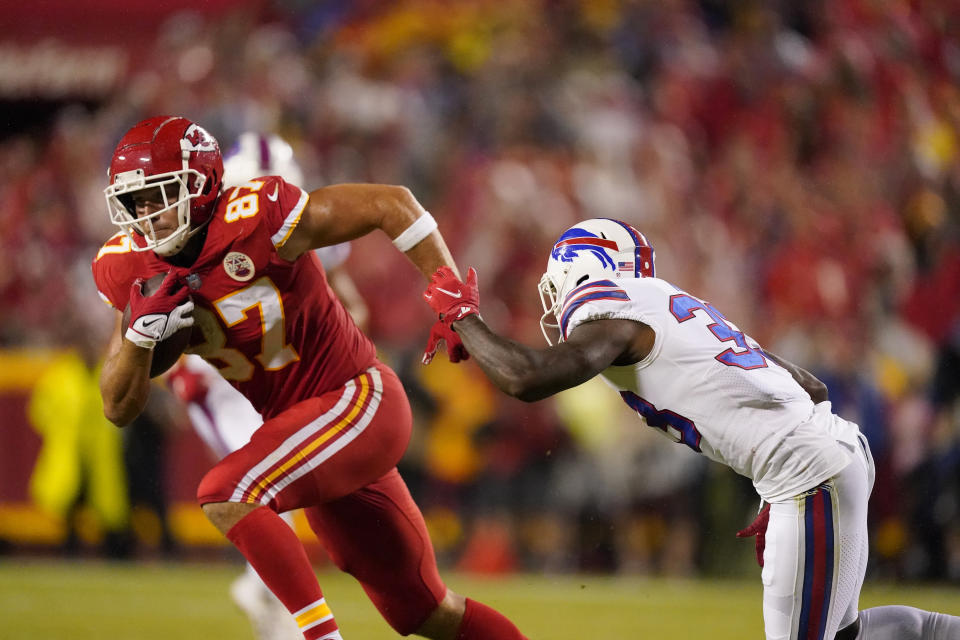 Kansas City Chiefs tight end Travis Kelce, left, catches a pass as Buffalo Bills cornerback Siran Neal defends during the first half of an NFL football game Sunday, Oct. 10, 2021, in Kansas City, Mo. (AP Photo/Charlie Riedel)