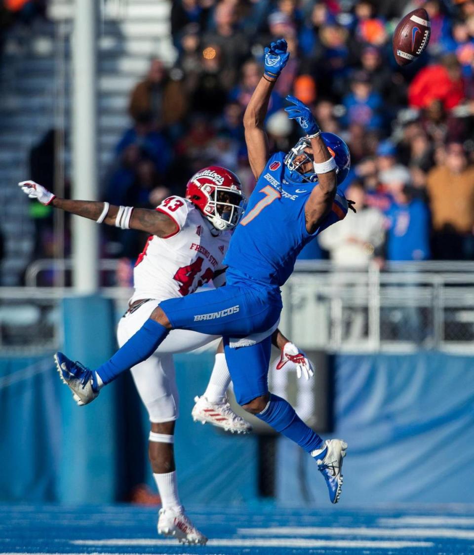 Boise State wide receiver Latrell Caples watches a high pass deflect off his hands defended by Fresno State defensive back Morice Norris in the first half of the Mountain West Championship, Saturday, Dec. 3, 2022, at Albertsons Stadium in Boise.