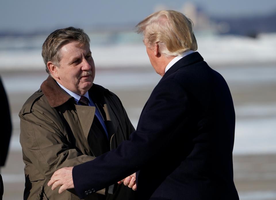 Rick Saccone, the Republican candidate in the special election for Pennsylvania's 18th District, greets President Donald Trump upon arrival at Pittsburgh International Airport on Jan. 18. Trump held a rally in support of the GOP tax cut legislation that doubled as a campaign event for Saccone.