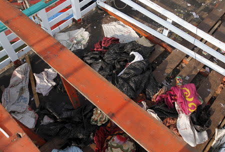 Discarded clothes and debris are seen on the deck of a fishing boat which carried Rohingya and Bangladeshi migrants to Indonesia, at a port in Lhokseumawe, Indonesia's Aceh Province May 13, 2015. REUTERS/Roni Bintang