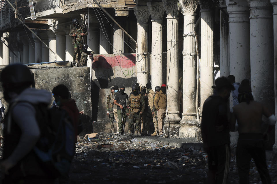 Security forces try to disperse anti-government protesters during clashes in Baghdad, Iraq, Saturday, Nov. 30, 2019. (AP Photo/Hadi Mizban)