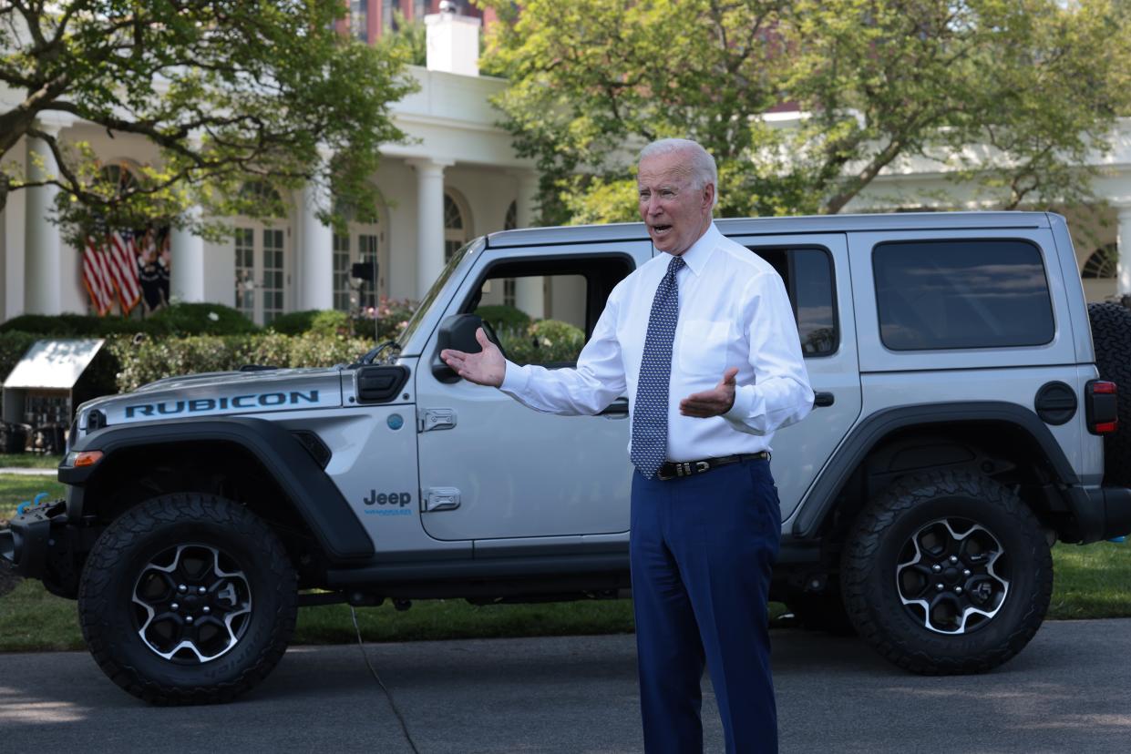 President Joe Biden answers questions from reporters after driving a Jeep Wrangler Rubicon Xe around the White House driveway following remarks during an event on the South Lawn of the White House 5 August 2021. (Getty Images)