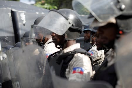 Haitian National Police (PNH) officers block the road towards President Moise house during a demonstration called by artists to demand the resignation of Haitian president Jovenel Moise, in the streets of Petion Ville, Port-au-Prince