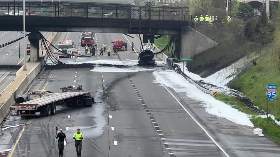 The charred remnants of two trucks and a passenger vehicle sit on shuttered I-95 in Norwalk, Connecticut after a fiery crash shut down the highway on May 2, 2024. / Credit: CBS New York
