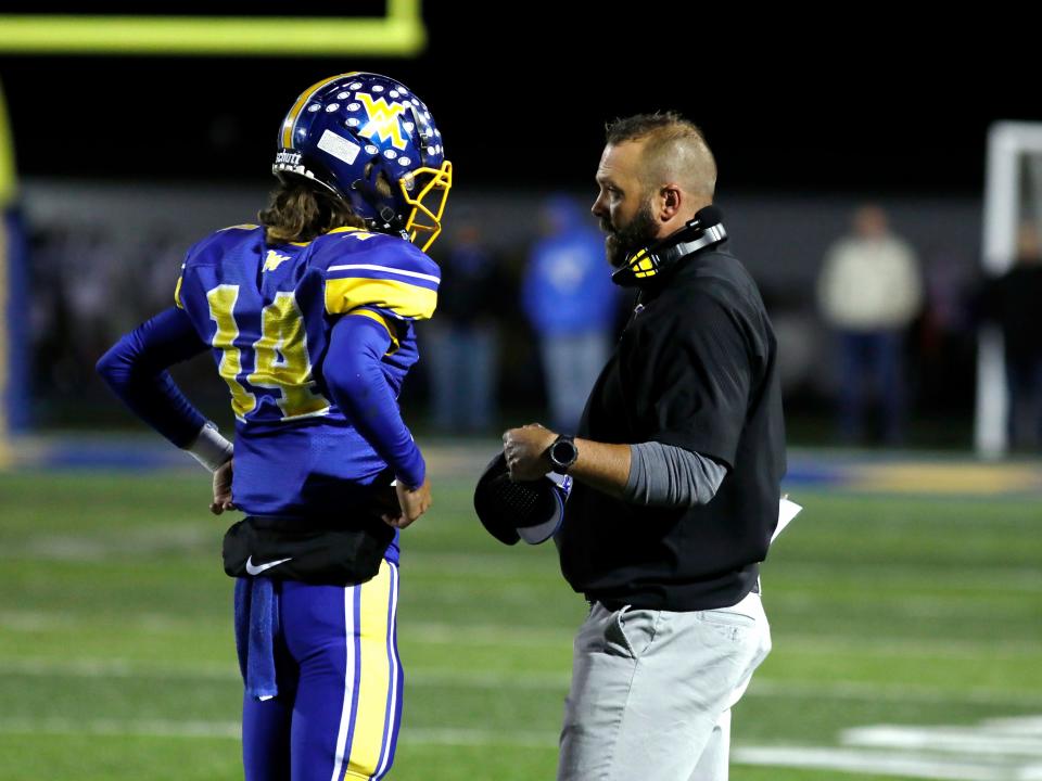 West Muskingum sophomore quarterback Jake Anton talks with head coach Nathan Brownrigg during a break in the action against Morgan on Oct. 7, 2022, in Falls Township, Ohio. Anton passed for three touchdowns in his team's 26-20 win and returns as one of the Muskingum Valley League's most productive passers.