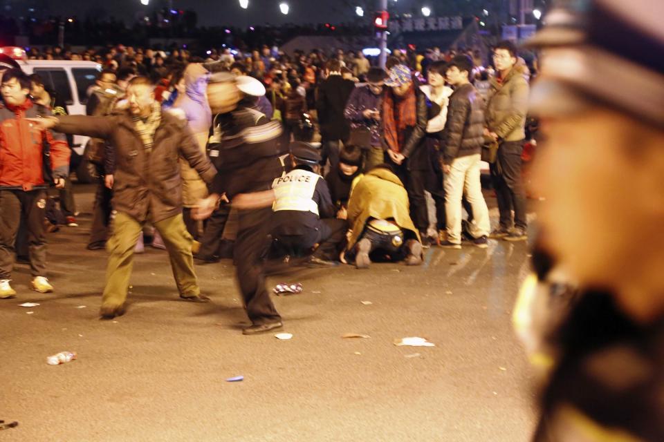 Police control the site after a stampede occurred during a New Year's celebration on the Bund