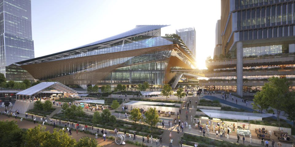 This image provided by ONE PARK×ONE TOWN shows an artist rendering of a waterfront stadium and skyscrapers planned to be built at the site of the former Tsukiji fish market in Tokyo. (ONE PARK×ONE TOWN via AP)