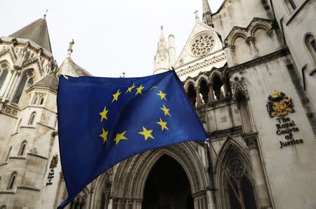 A European Union flag is waved outside the High Court in Central London, October 17, 2016. REUTERS/Stefan Wermuth