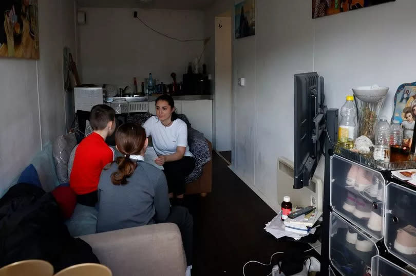 Three people sitting in a room