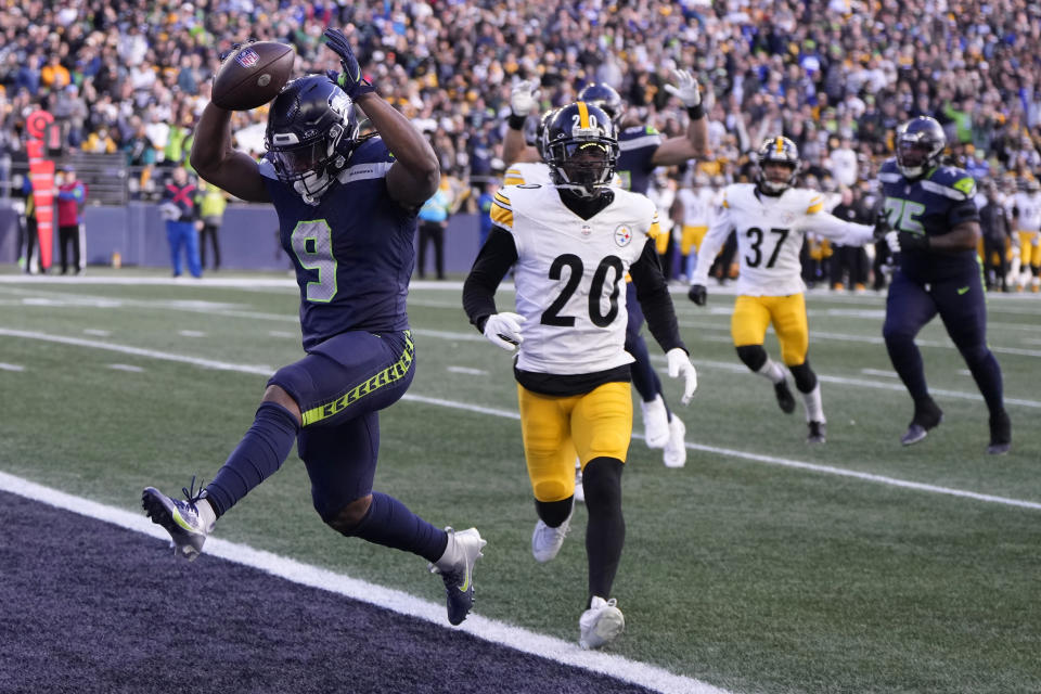 Seattle Seahawks running back Kenneth Walker III (9) scores a touchdown ahead of Pittsburgh Steelers cornerback Patrick Peterson (20) in the first half of an NFL football game Sunday, Dec. 31, 2023, in Seattle. (AP Photo/Stephen Brashear)