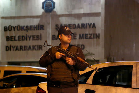 A riot policeman stands guard in front of the Metropolitan Municipality headquarters in the Kurdish-dominated southeastern city of Diyarbakir, Turkey, October 25, 2016. Picture taken October 25, 2016. REUTERS/Sertac Kayar