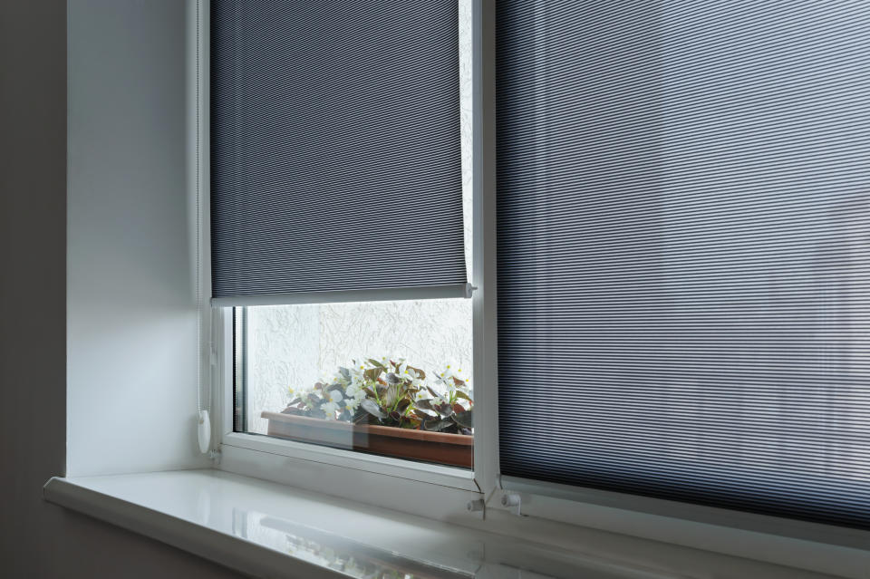 Gray roller shutters on the window