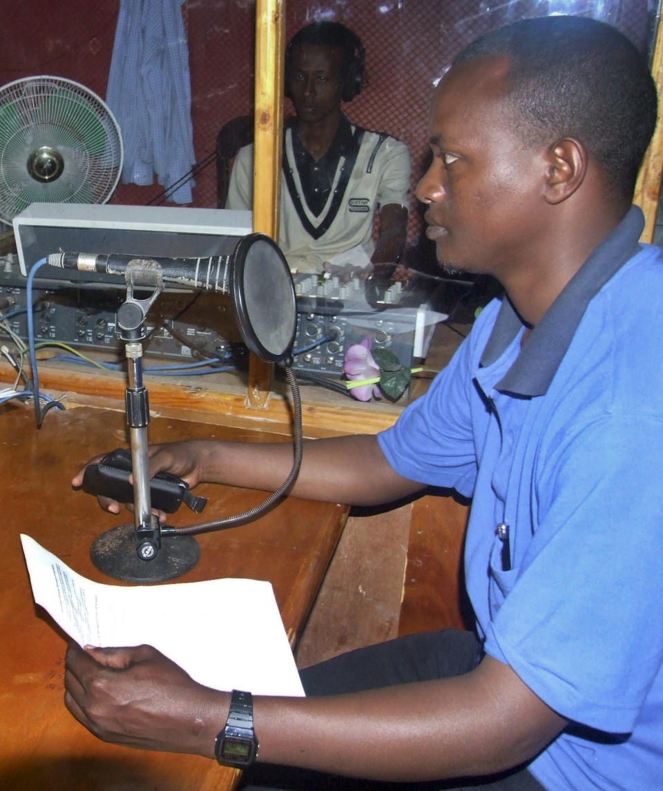 FILE - In this 2010 file photo, the director of Shabelle radio station Hassan Osman Abdi, right, popularly known as Hassan Fantastic, presents a programme on social issues in the radio station's studio in Mogadishu, Somalia, where he was shot dead by gunmen on Saturday, Jan. 28, 2012. The death of Somali television reporter Ahmed Saakin Farah on Tuesday, Oct. 23, 2012 brought the number of Somali journalists killed this year to 16, most in targeted attacks by gunmen who know there is little chance they will be caught or jailed, making Somalia the No. 2 country in the world, behind only Iraq, for unsolved journalist killings in recent years, according to the Committee to Protect Journalists. (AP Photo/Mohamed Sheikh Nor, File)