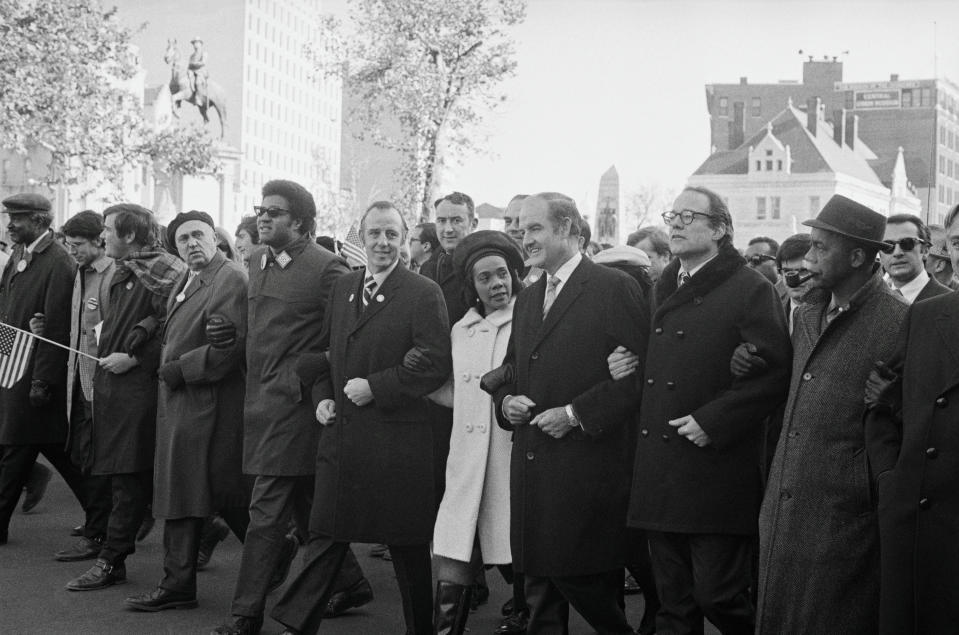 (Original Caption) Marching in the antiwar parade down Pennsylvania Avenue, are left to right: Senator Charles Goodell, (R-N.Y.), Mrs. Coretta Scott King, and Senator George S. McGovern, (D-S.D.). All three would address a rally at the Washington Monument following the mass march.