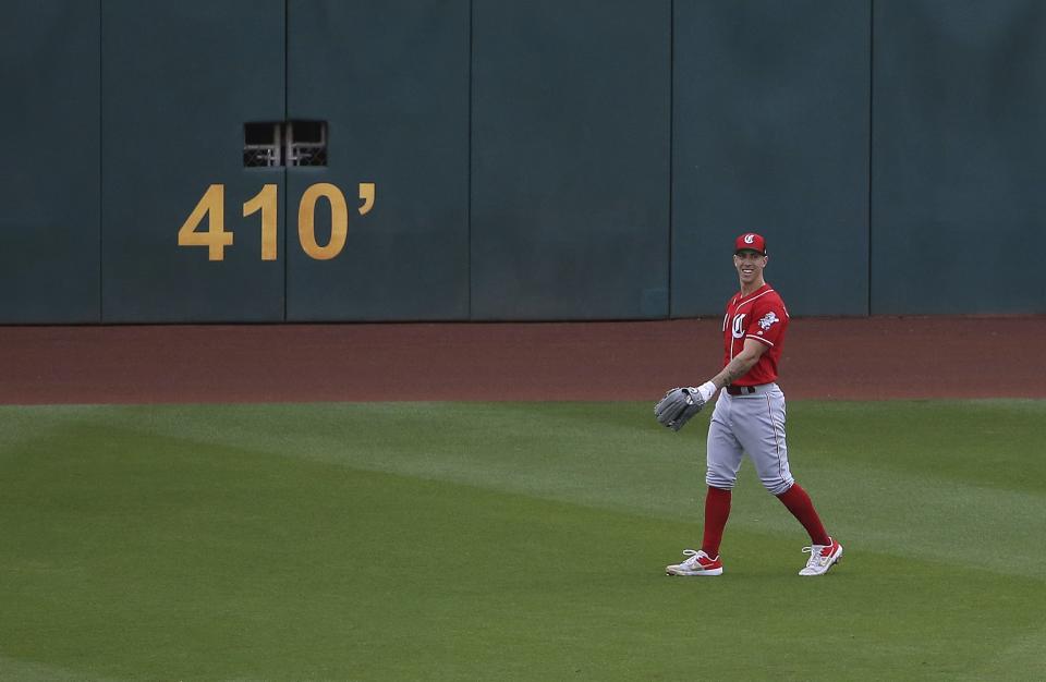 Cincinnati Reds' Michael Lorenzen, a pitcher who pitched the fifth inning for the Reds, smiles as he takes his spot in center field during the sixth inning of a spring training baseball game against the Cleveland Indians Monday, March 11, 2019, in Goodyear, Ariz. (AP Photo/Ross D. Franklin)