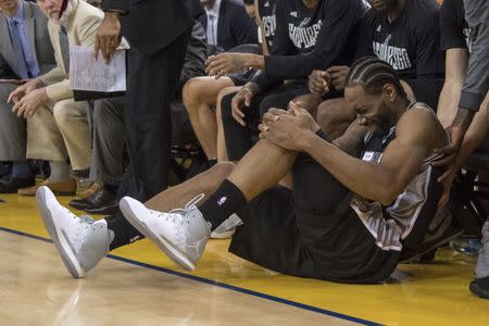 May 14, 2017; Oakland, CA, USA; San Antonio Spurs forward Kawhi Leonard (2) reacts after an injury during the third quarter in game one of the Western conference finals of the 2017 NBA Playoffs against the Golden State Warriors at Oracle Arena. The Warriors defeated the Spurs 113-111. Mandatory Credit: Kyle Terada-USA TODAY Sports