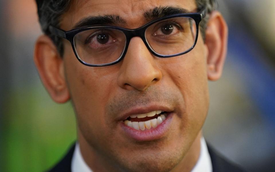 Rishi Sunak is pictured during a broadcast interview at a research laboratory in Oxfordshire yesterday - Jacob King/AFP