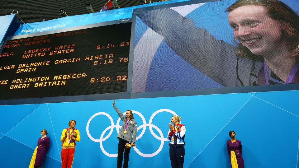 Katie Ledecky (center) waves to the crowd on the podium at London 2012. - Al Bello/Getty Images