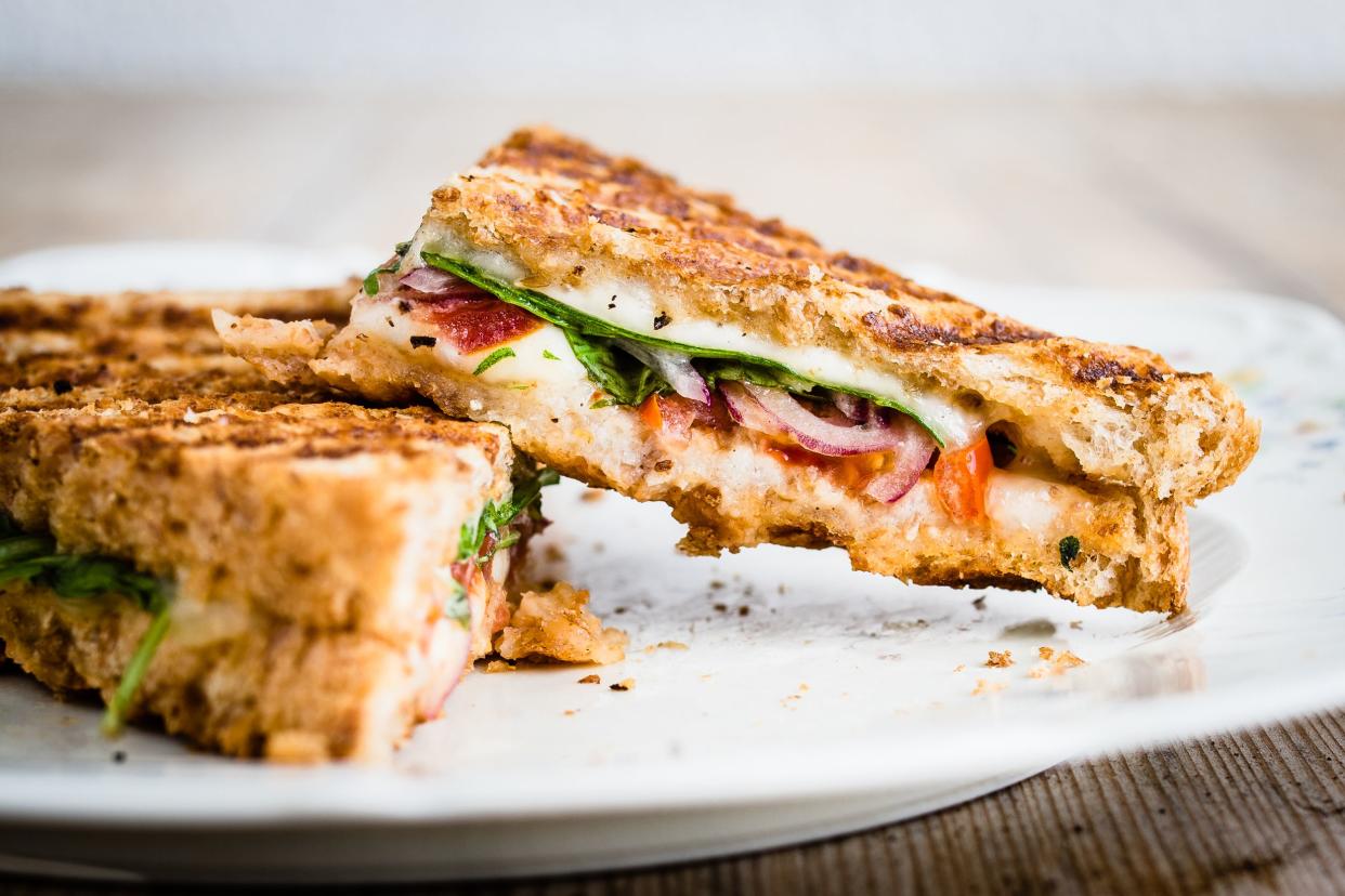 Grilled cheese with tomatoes, spinach, and onions