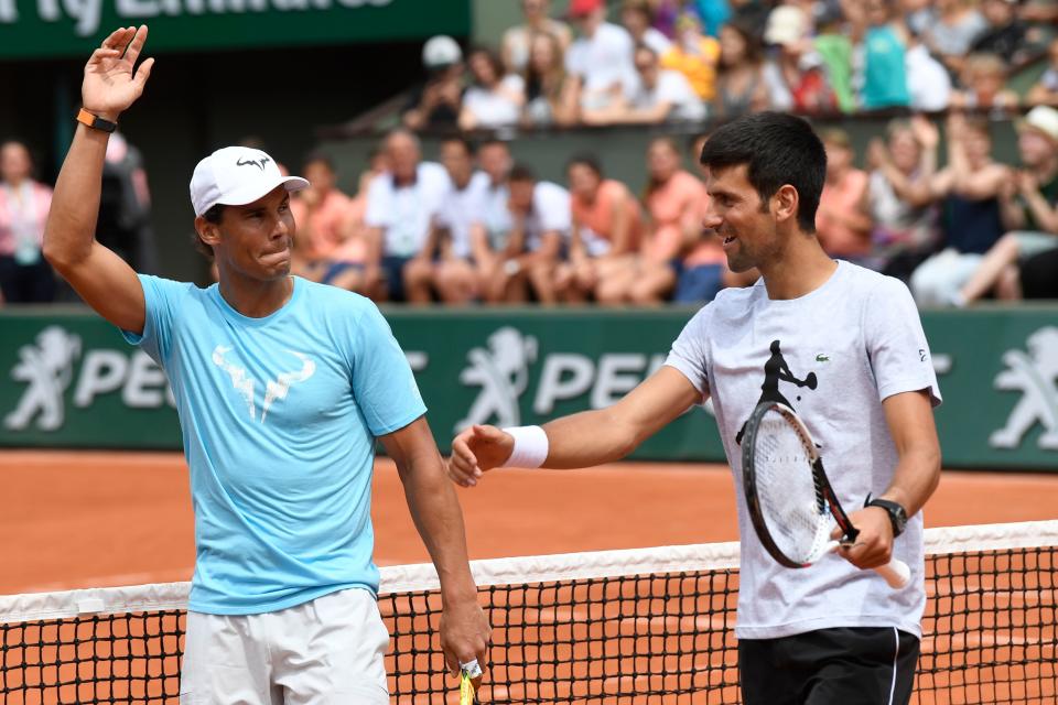 Rafael Nadal and Novak Djokovic near the tennis net. 