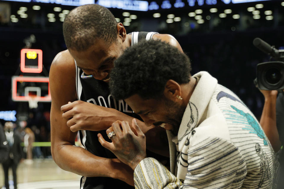 NEW YORK, NEW YORK - MARCH 13: Kevin Durant #7 laughs with Kyrie Irving #11 of the Brooklyn Nets after the second half against the New York Knicks at Barclays Center on March 13, 2022 in the Brooklyn borough of New York City. The Nets won 110-107. NOTE TO USER: User expressly acknowledges and agrees that, by downloading and or using this photograph, User is consenting to the terms and conditions of the Getty Images License Agreement. (Photo by Sarah Stier/Getty Images)