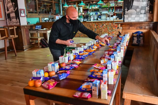 James Koch prepares free packed lunch bags for delivery at the Gallimaufry pub in Bristol