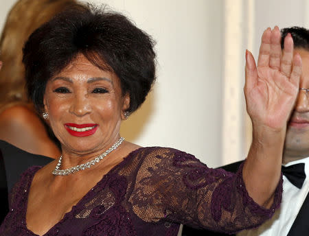 FILE PHOTO: Singer Shirley Bassey waves as she arrives at the Red Cross Gala in Monte Carlo, Monaco July 25, 2015. The Red Cross Gala is a traditional annual charity event in the Principality of Monaco. REUTERS/Jean-Paul Pelissier/File Photo