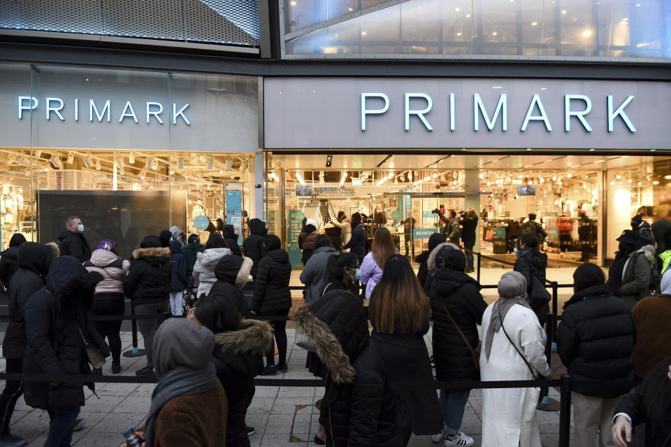 Early morning shoppers in Birmingham, England, Monday April 12, 2021. Millions of people in Britain will get their first chance in months for haircuts, casual shopping and restaurant meals on Monday, as the government takes the next step on its lockdown-lifting road map. (Jacob King/PA via AP)