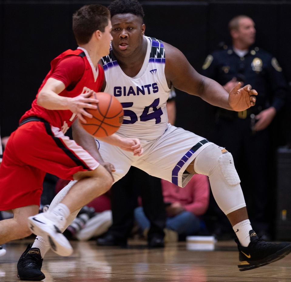 Center Grove's Spencer Piercefield (10) is defended by Ben Davis's Dawand Jones (54) during the Indiana 4A boys basketball state semifinal March 17, 2019, in Washington, Ind.