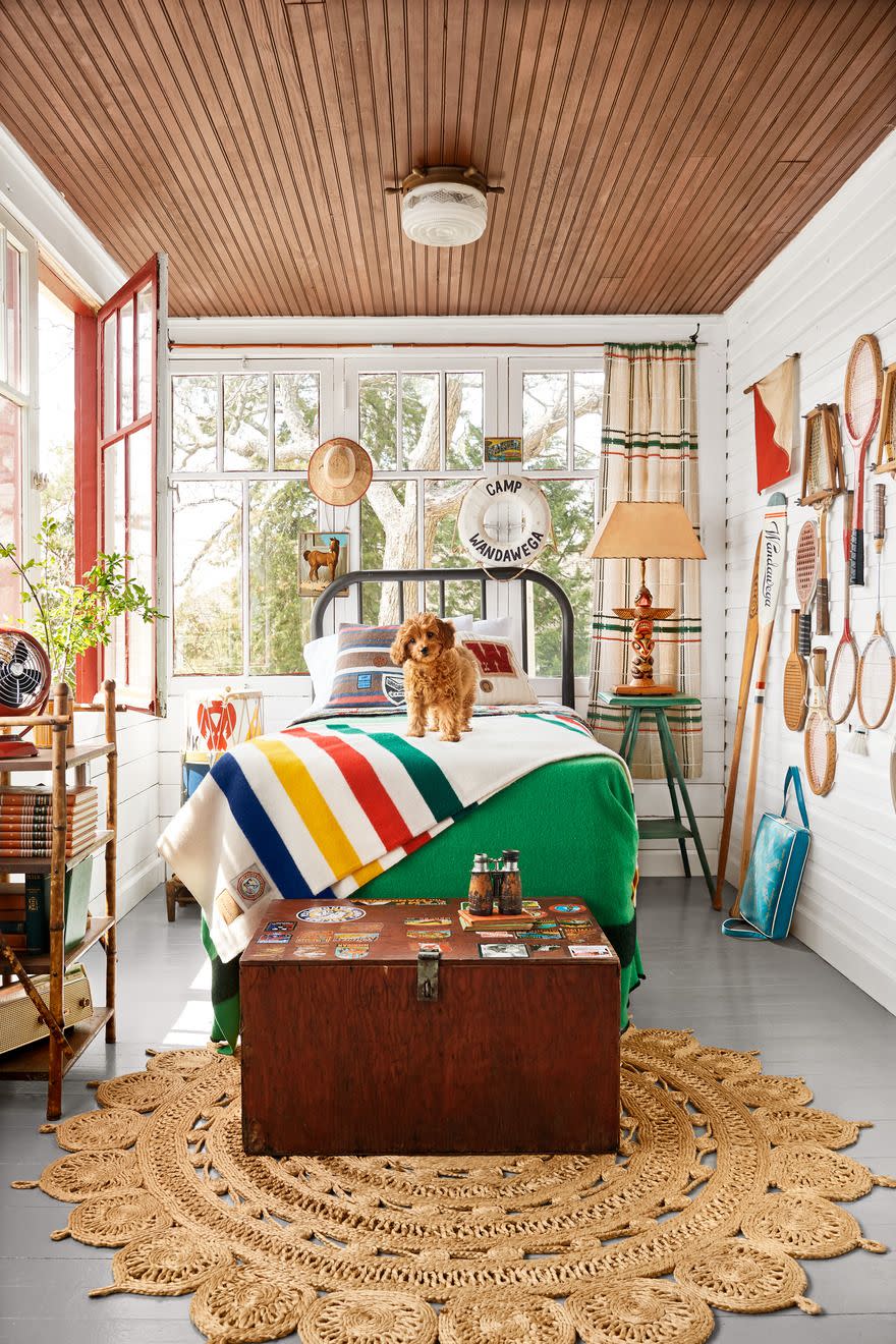 bedroom with vintage footlocker camp theme, dog on bed