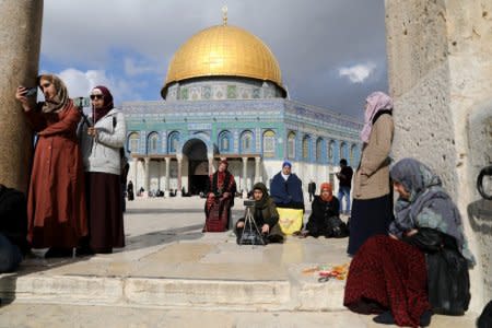 Worshippers sit around before Friday prayers on the compound known to Muslims as Noble Sanctuary and to Jews as Temple Mount in Jerusalem's Old City, as Palestinians call for a