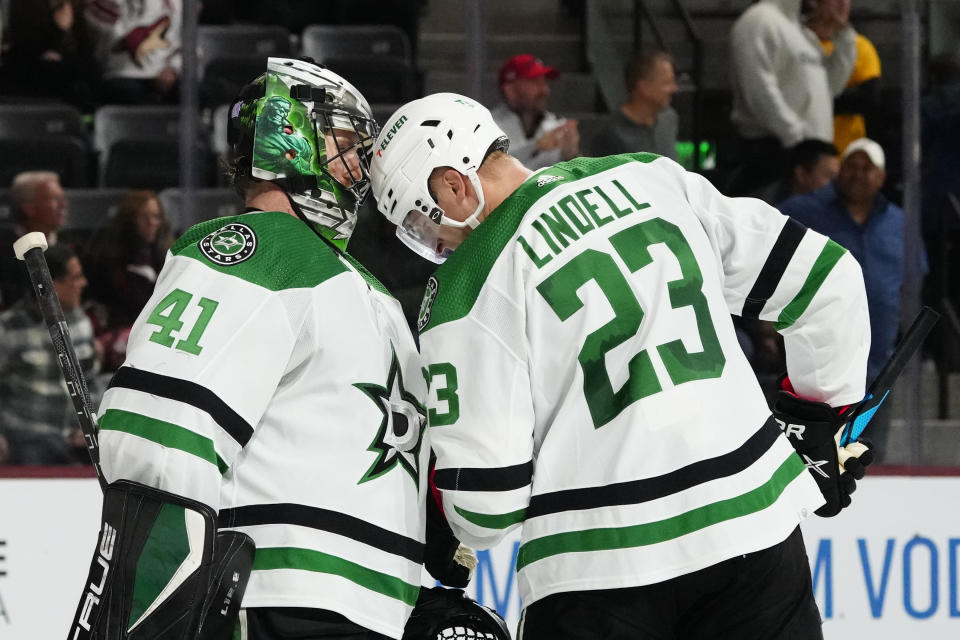 Dallas Stars goaltender Scott Wedgewood (41) celebrates with defenseman Esa Lindell (23) after the team's 7-2 win over the Arizona Coyotes in an NHL hockey game in Tempe, Ariz., Thursday, Nov. 3, 2022. (AP Photo/Ross D. Franklin)