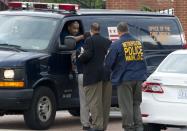 A van with the Washington Office of the Chief Medical Examiner leaves the Navy Yard following a shooting in Washington on September 16, 2013