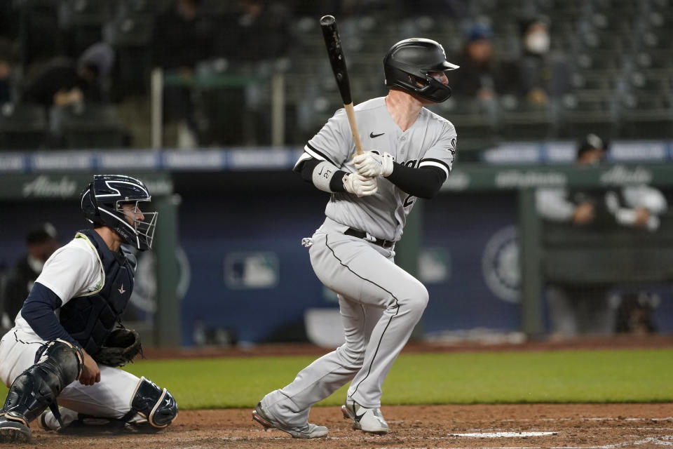 Chicago White Sox's Zack Collins follows through after hitting a two-RBI single that scored Adam Eaton and Jake Lamb during the fifth inning of a baseball game against the Seattle Mariners, Wednesday, April 7, 2021, in Seattle. (AP Photo/Ted S. Warren)