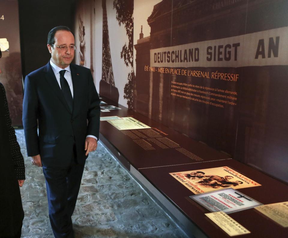 French President Francois Hollande visits the museum of Resistance at the Mont Valerien in Suresnes, West of Paris, Friday, Feb. 21, 2014, as part of a homage to French resistance fighters who fought during World War II, President Francois Hollande says two women who fought with the French Resistance during World War II will be inducted into Paris' renowned Pantheon, the eternal resting place of dozens of French greats. (AP Photo/Remy de la Mauviniere/Pool)