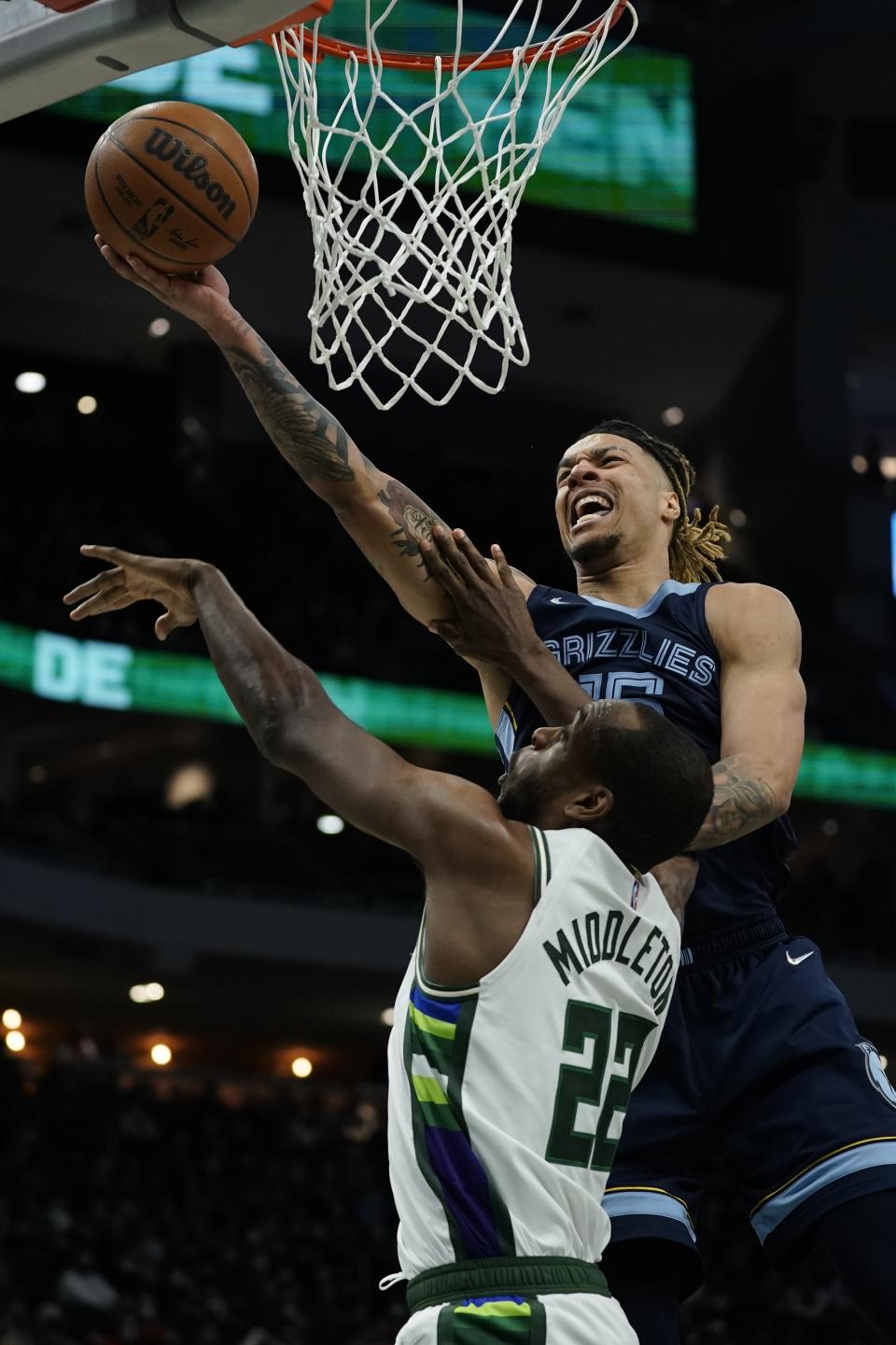 Memphis Grizzlies' Jon Teske is fouled by Milwaukee Bucks' Khris Middleton during the second half of an NBA basketball game Wednesday, Jan. 19, 2022, in Milwaukee. (AP Photo/Morry Gash)