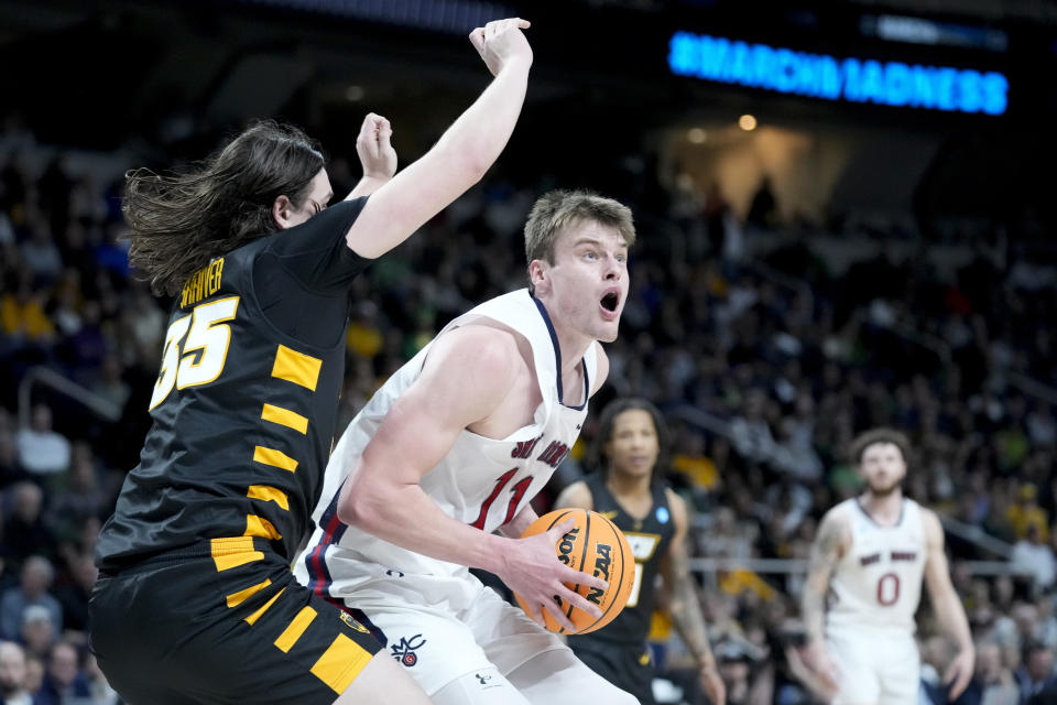 St. Mary's Mitchell Saxen (11) looks to pass against Virginia Commonwealth's David Shriver (35) in the second half of a first-round college basketball game in the NCAA Tournament, Friday, March 17, 2023, in Albany, N.Y. (AP Photo/John Minchillo)
