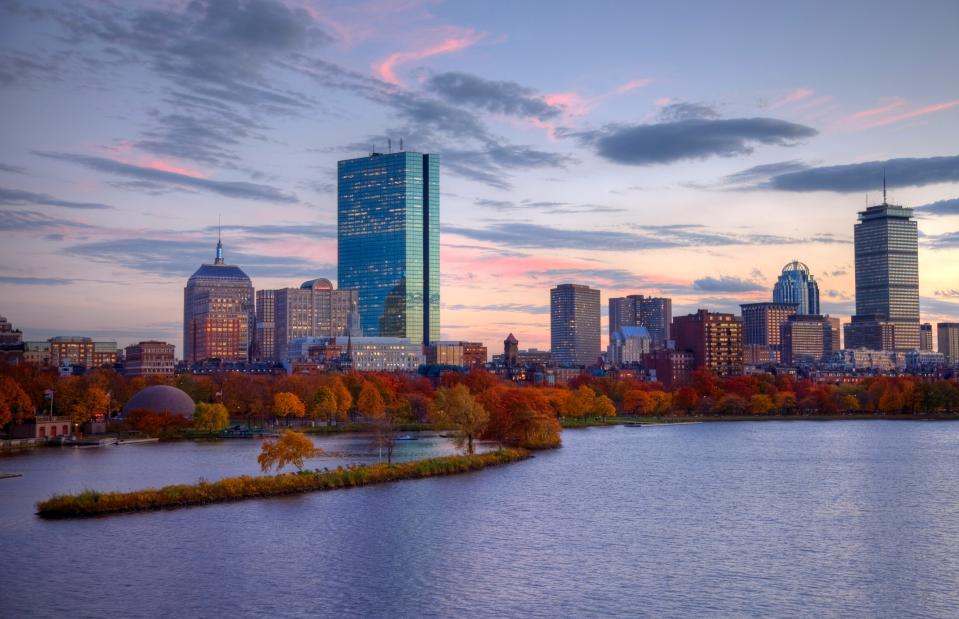 Boston skyline at sunset with yellow and red autumn trees