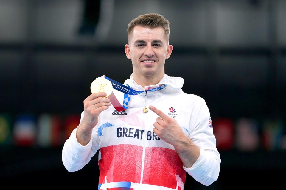 Great Britain’s Max Whitlock celebrates with his gold medal after winning the men’s pommel horse final in Tokyo (Mike Egerton/PA) (PA Wire)