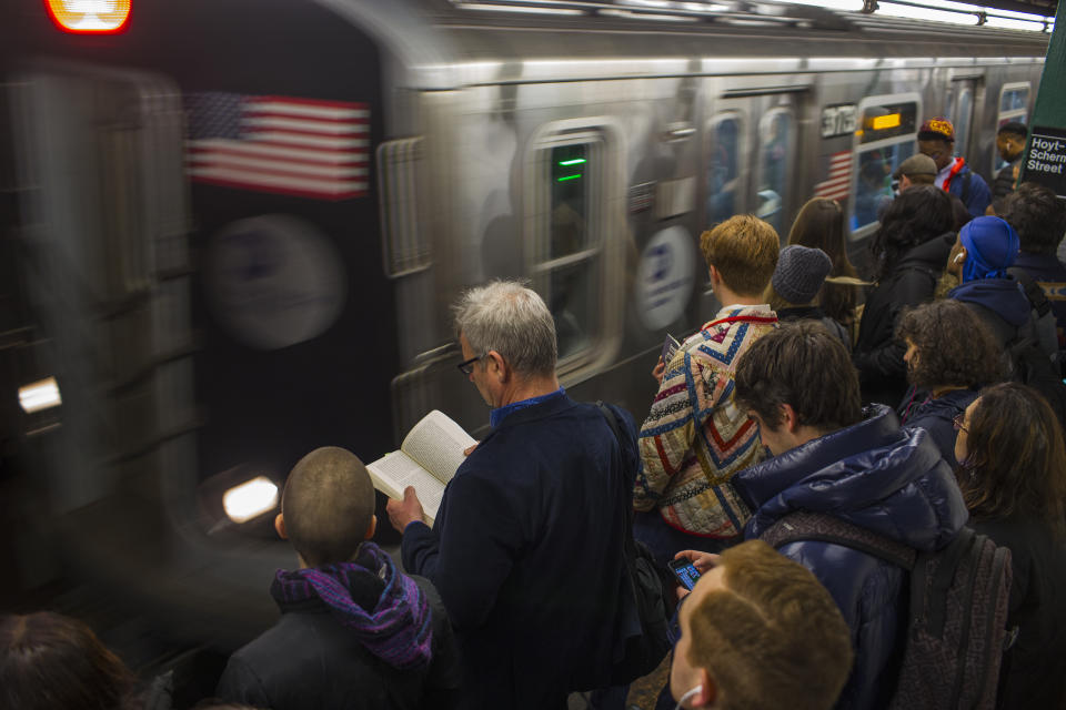 Morning commuters wait for overcrowded subway trains in Brooklyn, N.Y.