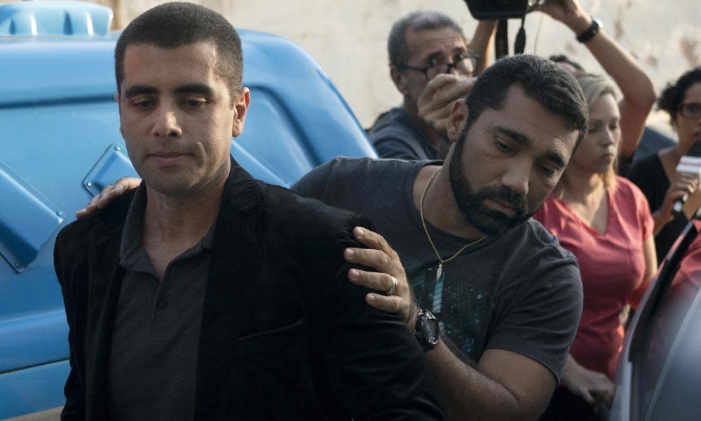 The celebrity plastic surgeon Denis Furtado is escorted by police after his arrest in Rio de Janeiro, Brazil on Thursday.