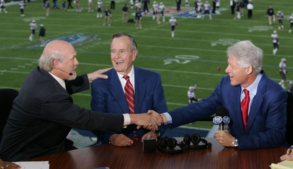 <p>Sportscaster Terry Bradshaw speaks with George H.W. Bush and Bill Clinton in the FOX Broadcast booth during the XXXIX Super Bowl pregame show at Alltel Stadium on February 6, 2005, in Jacksonville, Florida. </p>