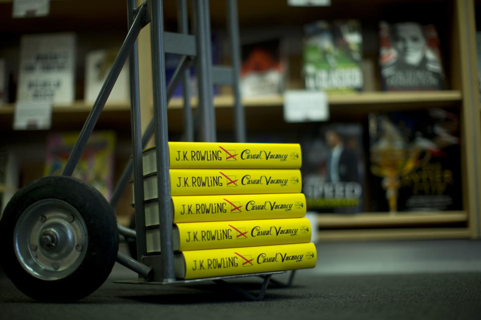 Copies of the "The Casual Vacancy" by author J.K. Rowling stand on a trolley ready to go on the shelves at a book store in London, Thursday, Sept. 27, 2012. British bookshops are opening their doors early as Harry Potter author J.K. Rowling launches her long anticipated first book for adults. Publishers have tried to keep details of the book under wraps ahead of its launch Thursday, but "The Casual Vacancy" has gotten early buzz about references to sex and drugs that might be a tad mature for the youngest "Potter" fans. (AP Photo/Matt Dunham)