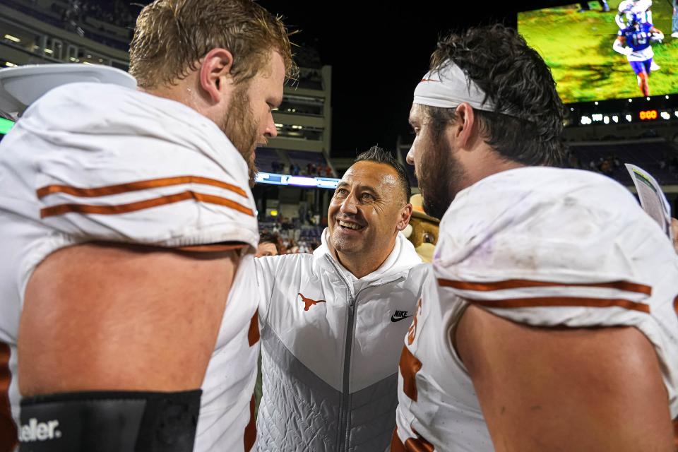 Texas center Jake Majors, right, celebrates a win over TCU last season with Longhorns head coach Steve Sarkisian and guard Hayden Conner. Majors and Conner are two of four returning starters on the offensive line, including likely first-round NFL draft pick Kelvin Banks Jr.