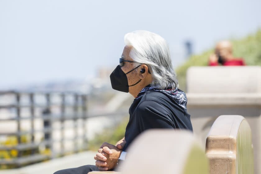 Redondo Beach, CA - May 14: A masked man takes in the coastal scene from Miramar Park, in Redondo Beach, CA, a day after the Centers for Disease Control and Prevention (CDC) loosened guidelines for vaccinated people, with masks no longer being necessary when outdoors or in most indoor situations, Friday, May 14, 2021. The new guidelines state that fully vaccinated people no longer need to wear a mask or physically distance in any setting, except where required by federal, state, local, tribal, or territorial laws, rules, and regulations, including local business and workplace guidance. (Jay L. Clendenin / Los Angeles Times)