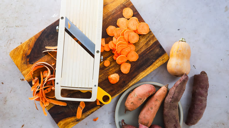Slicing sweet potatoes and squash with mandoline